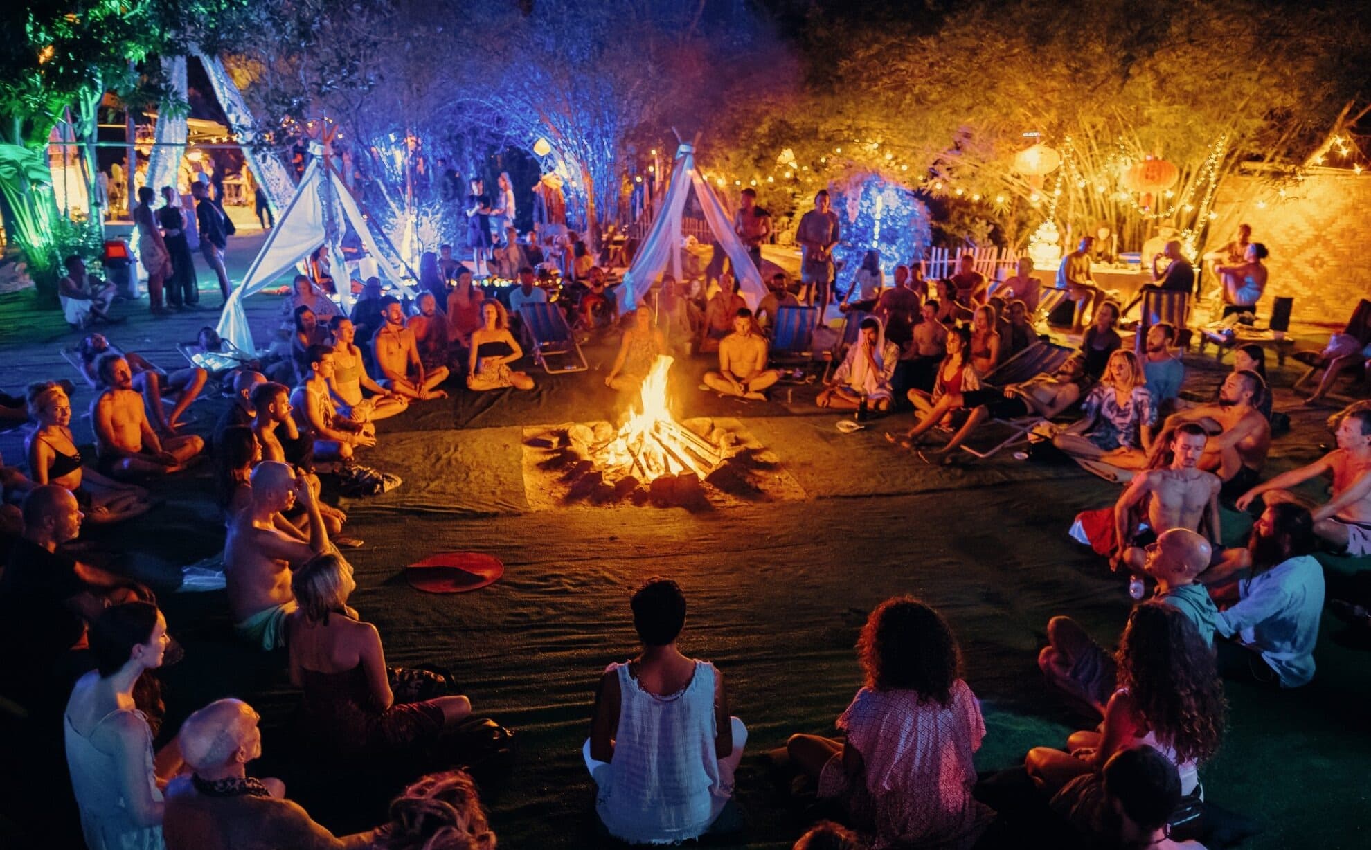 Community gathered around the fire for an evening ceremony at AUM