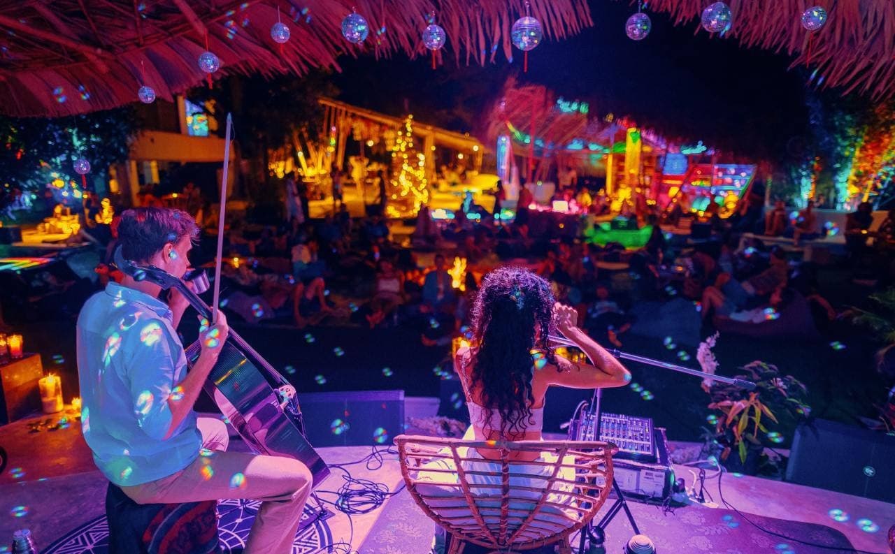 Live cello and violin on the AUM stage at night